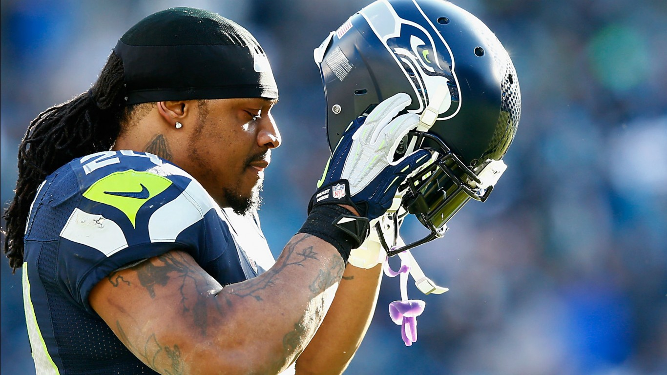 Marshawn Lynch With Helmet In Hand Wearing Blue Sports 